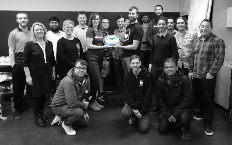 FastMail staff with Topicbox logo cake